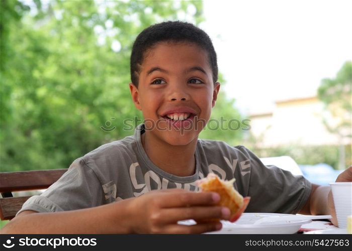 Child eating breakfast outside
