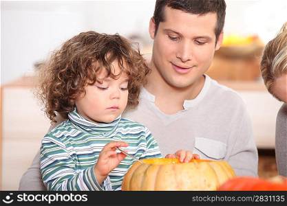 child emptying pumpkin