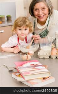 Child girl and grandmother baking cake stir dough