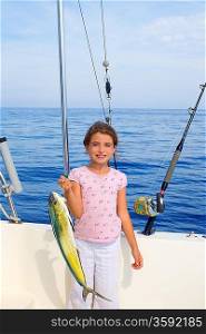 child girl fishing in boat with mahi mahi dorado fish catch with rod and trolling reels