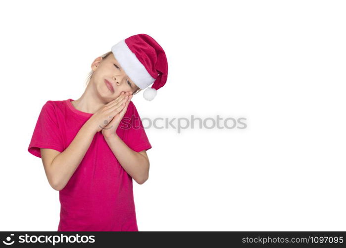 Child girl in santa hat and pink t-shirt smile and asks for something. Portrait of girl with long light brown hair in pink T-shirt isolated on white. Child girl in santa hat smile and pink t-shirt