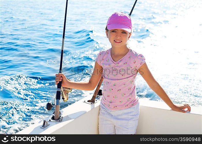 child girl sailing in fishing boat holding rod in blue sea