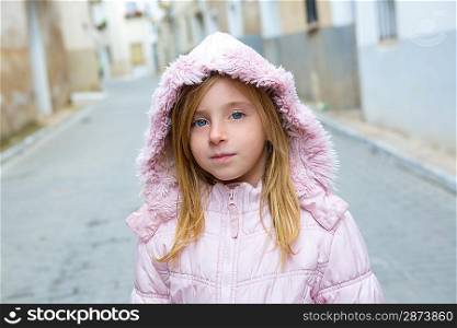 Child girl tourist walking in traditional Spain village pink winter fur hood