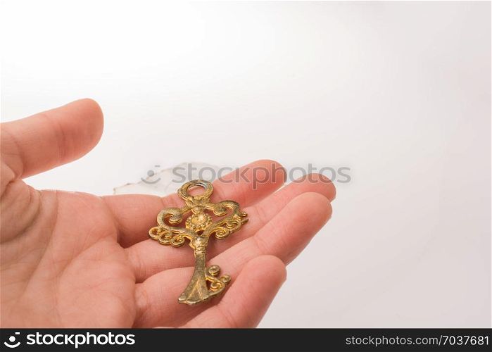 Child hand holding a retro styled golden color decorative key