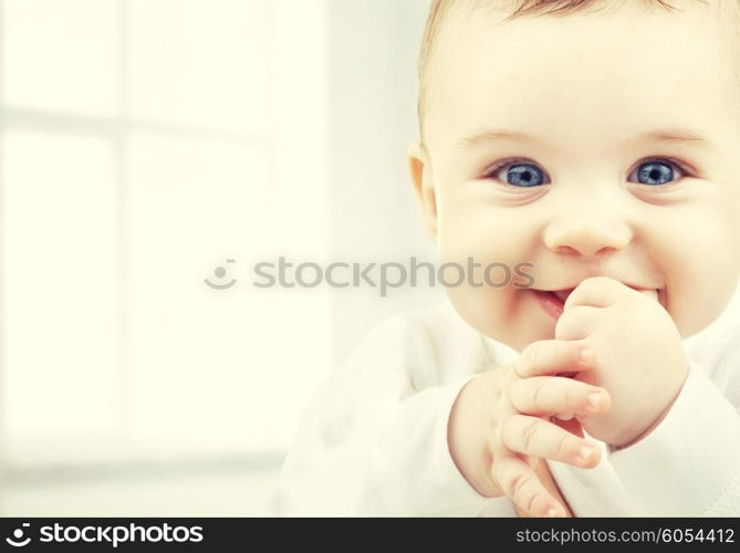 child, happiness and people concept - adorable baby