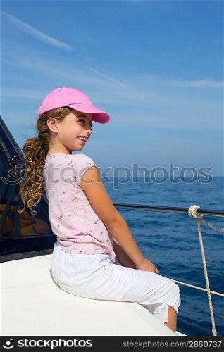 child happy girl sailing happy boat with cap at blue sea ocean