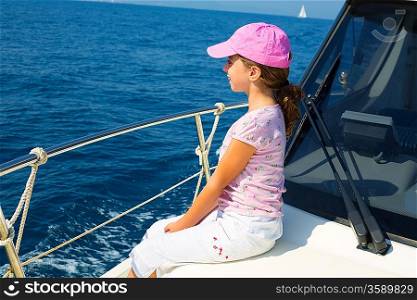 child happy girl sailing happy boat with cap at blue sea ocean