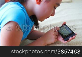 Child having fun with smart phone at home