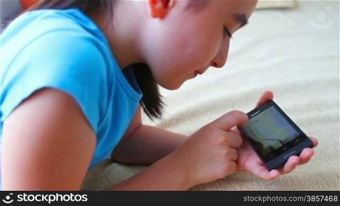 Child having fun with smart phone at home