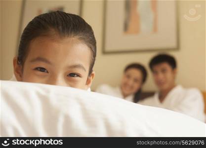 Child Hiding Behind Pillow