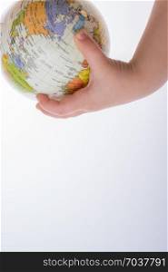 Child holding a globe and a pen in on a white background