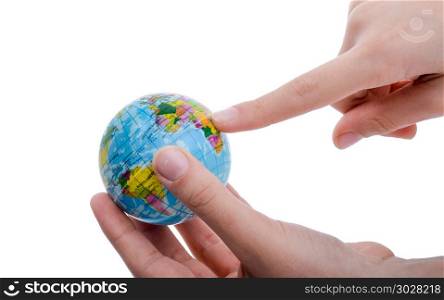 Child holding a globe. Child holding a small globe in hand on white background