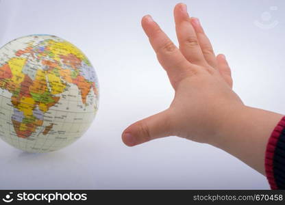 Child holding a globe in on a white background