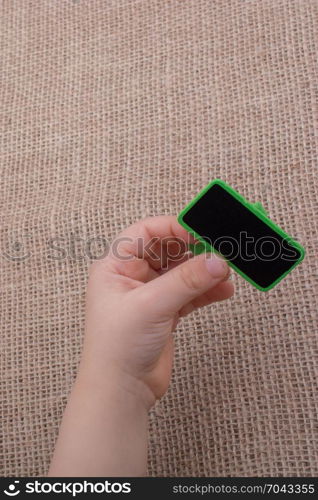 Child holding a notice board in hand on canvas