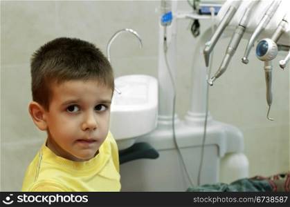 Child in a dentist?s chair in cabinet