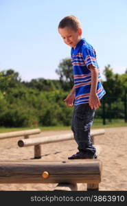 child in playground kid in action boy play on leisure equipment