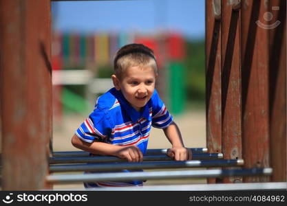 child in playground kid in action boy play on leisure equipment climbing