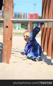 child in playground kid in action boy play on leisure equipment climbing