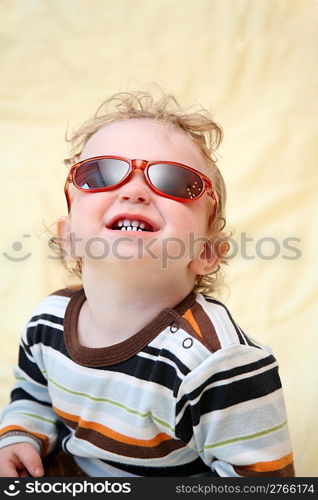 child in the sunglasses looks upward