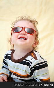 child in the sunglasses looks upward