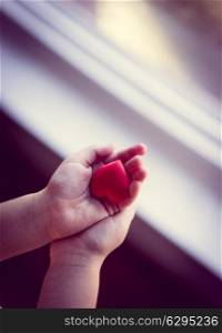 Child is holding a small heart