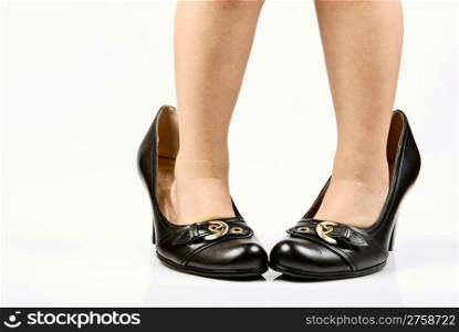 child legs in elegant adult shoes