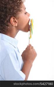 child licking lollipop