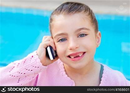 child little indented girl talking mobile phone in swimming pool