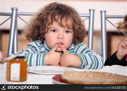 Child looking plate of pancakes