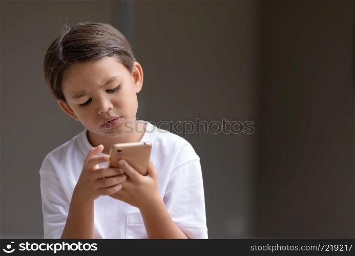 Child looking something on smart phone with intention.
