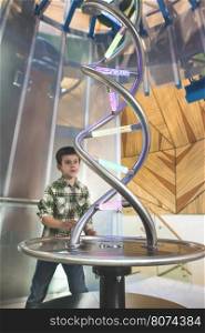 Child looks at a DNA sculpture.