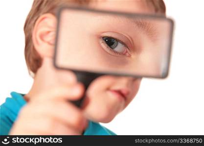child looks through magnifier