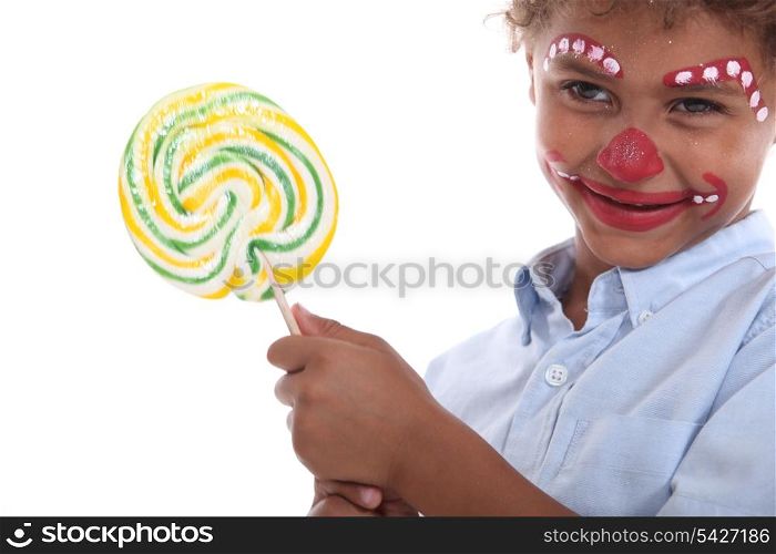 Child made-up holding a lollipop