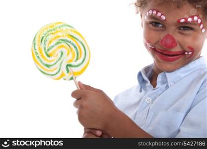 Child made-up holding a lollipop