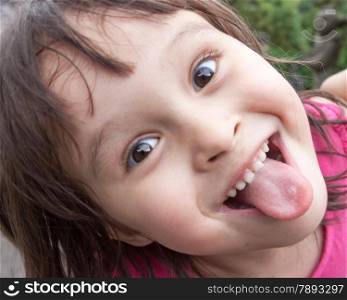 Child making funny face and sticking tongue out