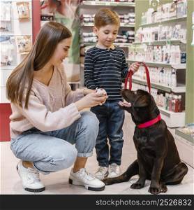 child mother pet shop with their dog
