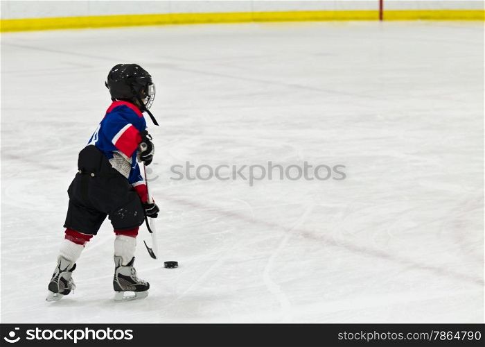 Child on a breakaway during ice hockey game