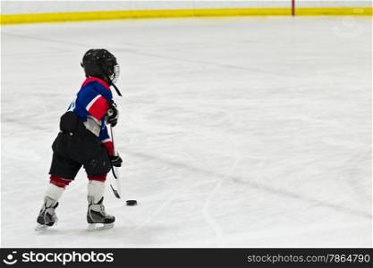 Child on a breakaway during ice hockey game