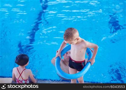 child on swimming pool learning to swim w