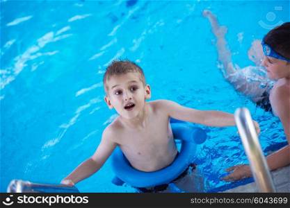 child on swimming pool learning to swim w