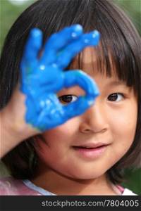 child painting and playing with finger painting colours (chinese child)