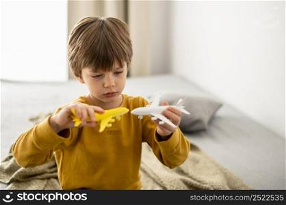 child playing with airplane figurines