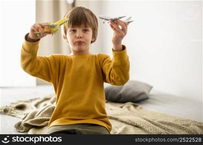 child playing with airplane figurines home