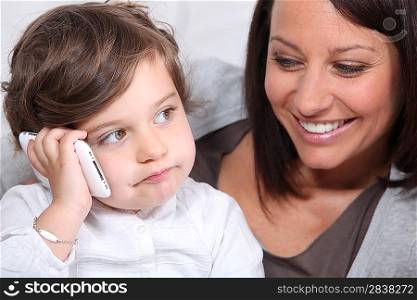 Child playing with his mother&acute;s mobile phone