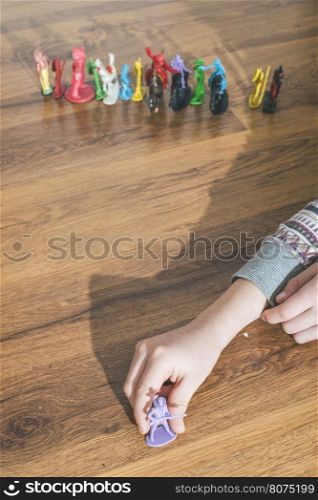 Child playing with small vintage toys on the floor