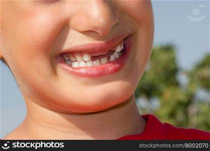 Child plays a cheerful smile without showing teeth