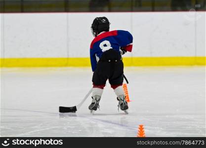 Child practicing ice hockey