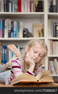 child reading a book at the private library