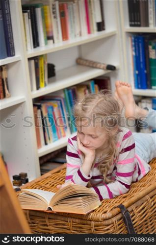 child reading a book at the private library