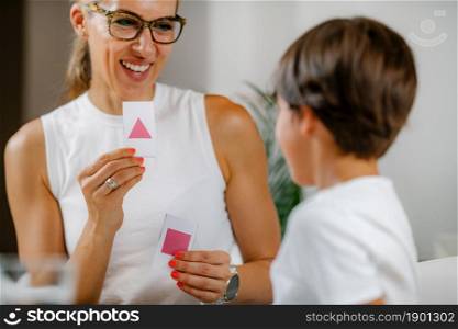 Child recognizing shapes in a preschool assessment test.